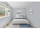 Comfortable bedroom featuring a large window, light blue walls, and coordinated decor at 381 Mountain Cloud Cir, Highlands Ranch, CO 80126
