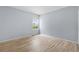 Bright bedroom with a large window, light blue walls, and wood-look flooring at 381 Mountain Cloud Cir, Highlands Ranch, CO 80126