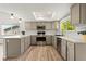 Charming kitchen with stainless steel appliances, skylight, hardwood floors and a subway tile backsplash at 381 Mountain Cloud Cir, Highlands Ranch, CO 80126
