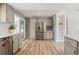 Open kitchen with stainless steel appliances, hardwood floors and adjacent pantry at 381 Mountain Cloud Cir, Highlands Ranch, CO 80126