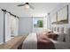 Comfortable bedroom with barn-door access to the bathroom and a soothing color palette at 381 Mountain Cloud Cir, Highlands Ranch, CO 80126