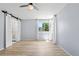 Bright bedroom with a large window and barn-door access to the bathroom at 381 Mountain Cloud Cir, Highlands Ranch, CO 80126