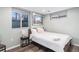 Basement bedroom with a queen bed and large windows at 4675 Reed St, Wheat Ridge, CO 80033