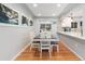 Bright dining area with a table for four, hardwood floors, and kitchen views at 4675 Reed St, Wheat Ridge, CO 80033