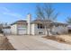 Ranch home with attached garage and a long driveway at 4675 Reed St, Wheat Ridge, CO 80033