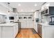 Updated kitchen featuring white cabinetry, gas range, and an island at 4675 Reed St, Wheat Ridge, CO 80033