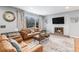 Living room features a fireplace, hardwood floors, and large windows at 4675 Reed St, Wheat Ridge, CO 80033