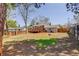 Large fenced backyard featuring a wooden deck, patio, and mature trees offering lots of privacy at 3785 S Benton Way, Denver, CO 80235