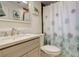 Bright bathroom with a sink, toilet, shower, and tub at 3785 S Benton Way, Denver, CO 80235