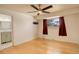 This bedroom features a ceiling fan, hardwood floors, and a closet with mirrored doors at 3785 S Benton Way, Denver, CO 80235