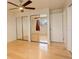 Bedroom featuring a closet with mirrored doors, a ceiling fan, and hardwood floors at 3785 S Benton Way, Denver, CO 80235