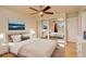 A comfortable bedroom features a ceiling fan, a closet with mirrored doors, and a neutral color palette at 3785 S Benton Way, Denver, CO 80235