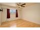 Well-lit bedroom with a ceiling fan, hardwood floors, and a view of the outside at 3785 S Benton Way, Denver, CO 80235