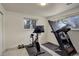 A home gym featuring a treadmill, spin bike, and natural light at 3785 S Benton Way, Denver, CO 80235