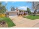 Charming home with a two-car garage, lush lawn, and mature trees at 3785 S Benton Way, Denver, CO 80235