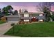 Charming home with mature trees, green lawn, colorful flower beds, and a cozy front porch at 3785 S Benton Way, Denver, CO 80235