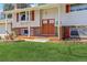Inviting home featuring a brick facade, colorful front door, and manicured lawn at 3785 S Benton Way, Denver, CO 80235
