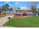 Charming home with mature trees, green lawn, colorful flower beds, and a cozy front porch at 3785 S Benton Way, Denver, CO 80235