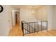Bright hallway with light wood floors and decorative chandelier at 3785 S Benton Way, Denver, CO 80235