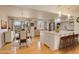 Bright kitchen and dining area featuring a kitchen island with bar stool seating and ample cabinet space at 3785 S Benton Way, Denver, CO 80235