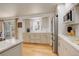 An eat-in kitchen features generous counter space, modern appliances, and access to the home's deck at 3785 S Benton Way, Denver, CO 80235