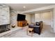 Cozy basement living room with fireplace, TV, and comfortable seating at 3785 S Benton Way, Denver, CO 80235