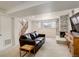 Well lit basement living room with sofa and fireplace at 3785 S Benton Way, Denver, CO 80235