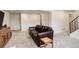 Spacious basement with a comfortable leather sofa and bright lighting at 3785 S Benton Way, Denver, CO 80235