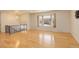 Open concept with large windows, hardwood floors, and modern chandelier at 3785 S Benton Way, Denver, CO 80235