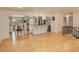 Open concept floor plan with modern kitchen, stainless steel appliances, and hardwood floors at 3785 S Benton Way, Denver, CO 80235