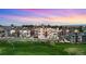 Aerial view of the neighborhood showcasing modern homes, golf course, and mountain views at 4625 W 50Th Ave # 309, Denver, CO 80212