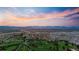 Expansive aerial view of golf course, city, and mountains during a colorful sunset at 4625 W 50Th Ave # 309, Denver, CO 80212