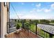 Balcony with an outdoor table and chairs overlooking a beautiful golf course and distant mountain views at 4625 W 50Th Ave # 309, Denver, CO 80212