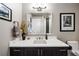 Bathroom vanity with a white countertop and a decorative mirror at 4625 W 50Th Ave # 309, Denver, CO 80212