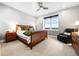 Spacious bedroom with a ceiling fan, large window and a wooden bed frame at 4625 W 50Th Ave # 309, Denver, CO 80212