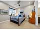 Bedroom with blue patterned bedding, a ceiling fan and a bright window at 4625 W 50Th Ave # 309, Denver, CO 80212