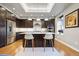 Bright, modern kitchen with dark wood cabinets, stainless steel appliances, and a large island with seating at 4625 W 50Th Ave # 309, Denver, CO 80212