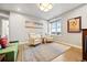 Sitting room featuring cream-colored chairs and a window with neighborhood views at 4625 W 50Th Ave # 309, Denver, CO 80212