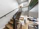 Staircase with dark metal railings and hardwood steps. Kitchen visible below at 4625 W 50Th Ave # 309, Denver, CO 80212