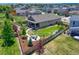 Aerial view captures the home's backyard, including a patio, firepit, and manicured lawn at 177 Vista Cliff Cir, Castle Rock, CO 80104