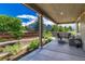 Covered patio area featuring outdoor seating, lovely views, and manicured landscaping at 177 Vista Cliff Cir, Castle Rock, CO 80104