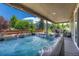 Covered patio features a hot tub with a beautifully landscaped backyard at 177 Vista Cliff Cir, Castle Rock, CO 80104