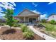 Backyard features a covered patio with manicured landscaping and a walkway to a fire pit at 177 Vista Cliff Cir, Castle Rock, CO 80104