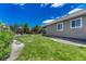 Well-maintained backyard featuring a green lawn, attractive landscaping, and privacy fencing at 177 Vista Cliff Cir, Castle Rock, CO 80104