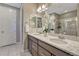 Bathroom featuring double sinks with granite countertops and a glass-enclosed shower at 177 Vista Cliff Cir, Castle Rock, CO 80104