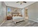 Serene bedroom boasts ample windows, wood-look floors, and a barn door to the en-suite bathroom at 177 Vista Cliff Cir, Castle Rock, CO 80104