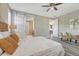 Bright bedroom featuring a ceiling fan, seating area, and sliding barn doors to the hallway at 177 Vista Cliff Cir, Castle Rock, CO 80104