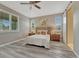 Spacious bedroom with light-filled windows, a ceiling fan, and a sliding barn door to the bathroom at 177 Vista Cliff Cir, Castle Rock, CO 80104