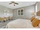 Bright bedroom featuring large window with shutters, ceiling fan, and seating area at 177 Vista Cliff Cir, Castle Rock, CO 80104