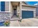 Inviting entryway with stone accents, a covered porch, and a two-car garage, adding to the home's curb appeal at 177 Vista Cliff Cir, Castle Rock, CO 80104